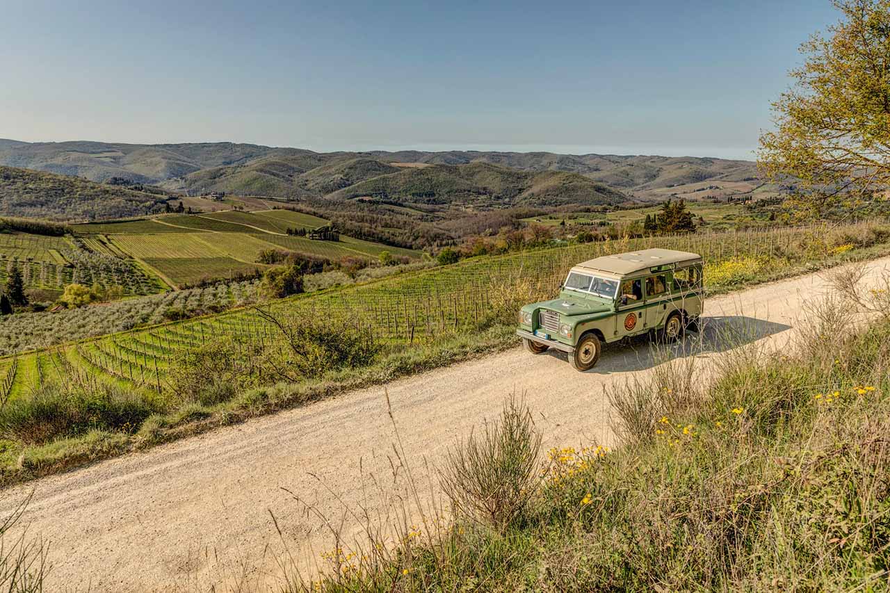 Chianti Vintage Expeditions - vintage Land Rover on a country road through the vineyards